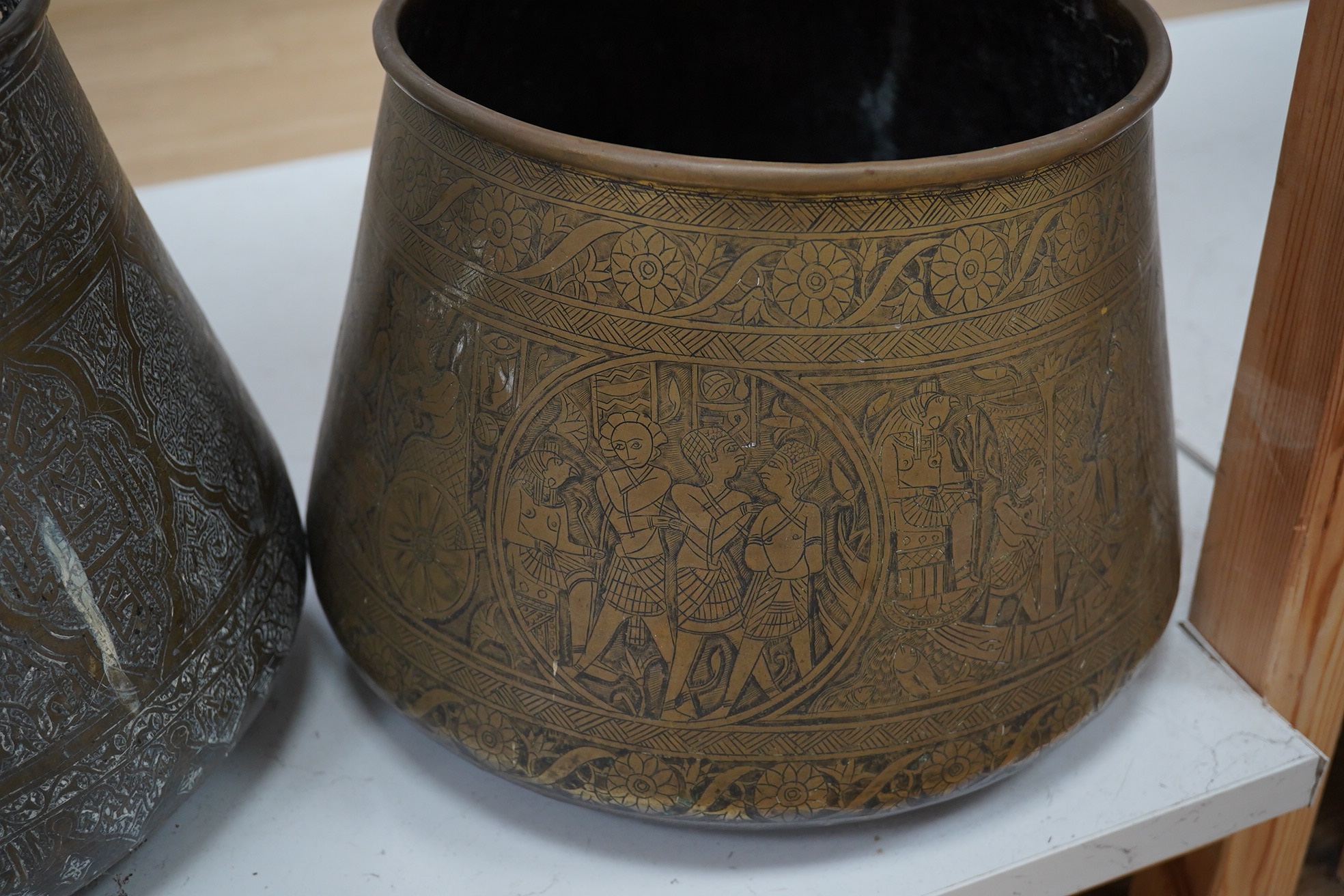 Two Benares engraved brass jardinieres, one with a pierced panels near the rim, 25cm high. Condition - fair